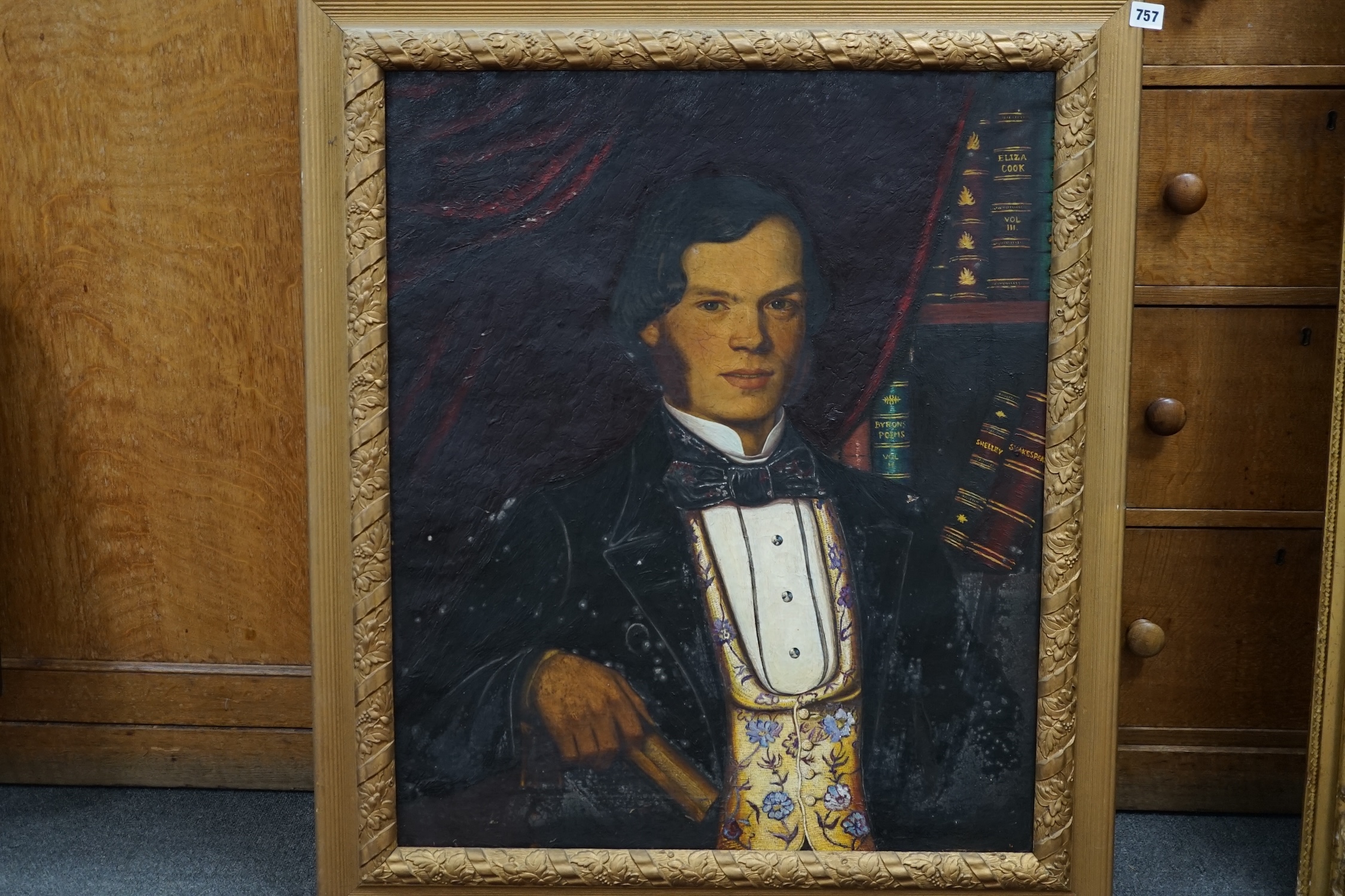 19th century, naive English School, oil on canvas, Portrait of a gentleman before various novels, including Eliza Cook, Byron's Poems and Shakespeare, 74 x 61cm. Condition - poor